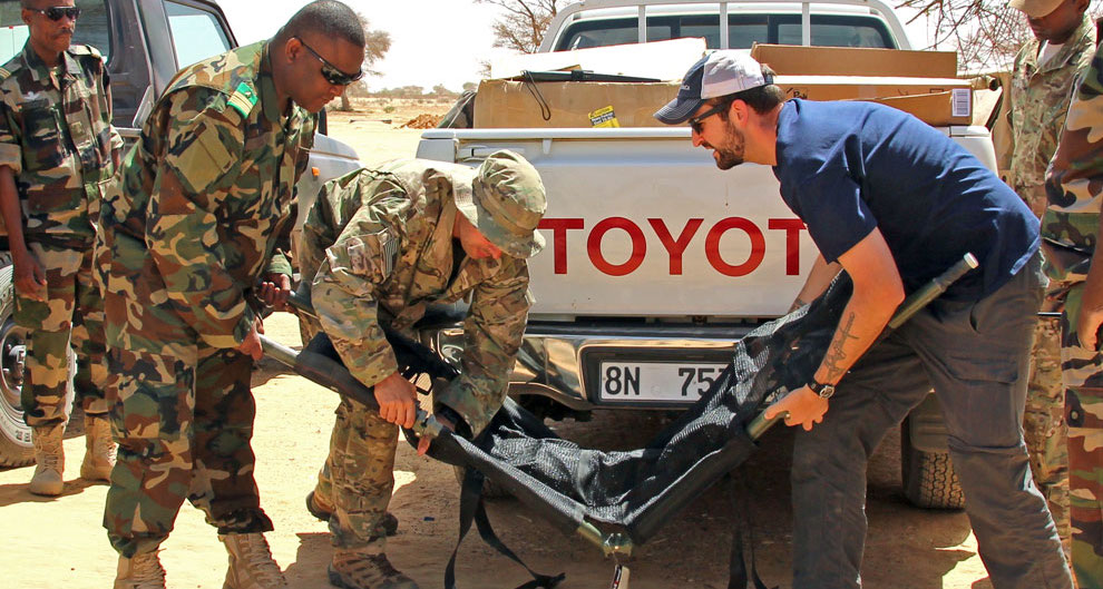 SoA's Isaac Eagan setting up a donated stretcher with a US Army team and Nigerien soldiers