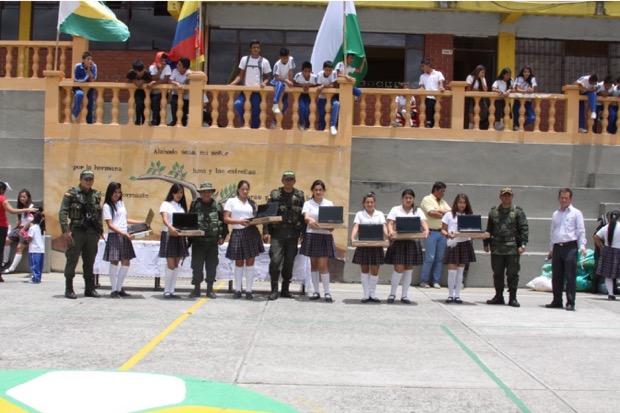 Students from the agricultural school receive laptops at a ceremony held by the Nariño police