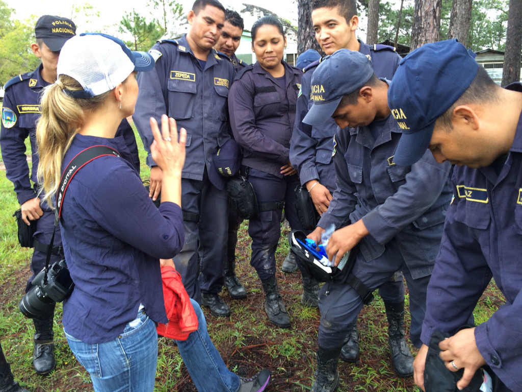 Reyes and Honduran Police discussing Individual First-Aid Kits (IFAKs) with SoA Field Rep Nicholette Doliva