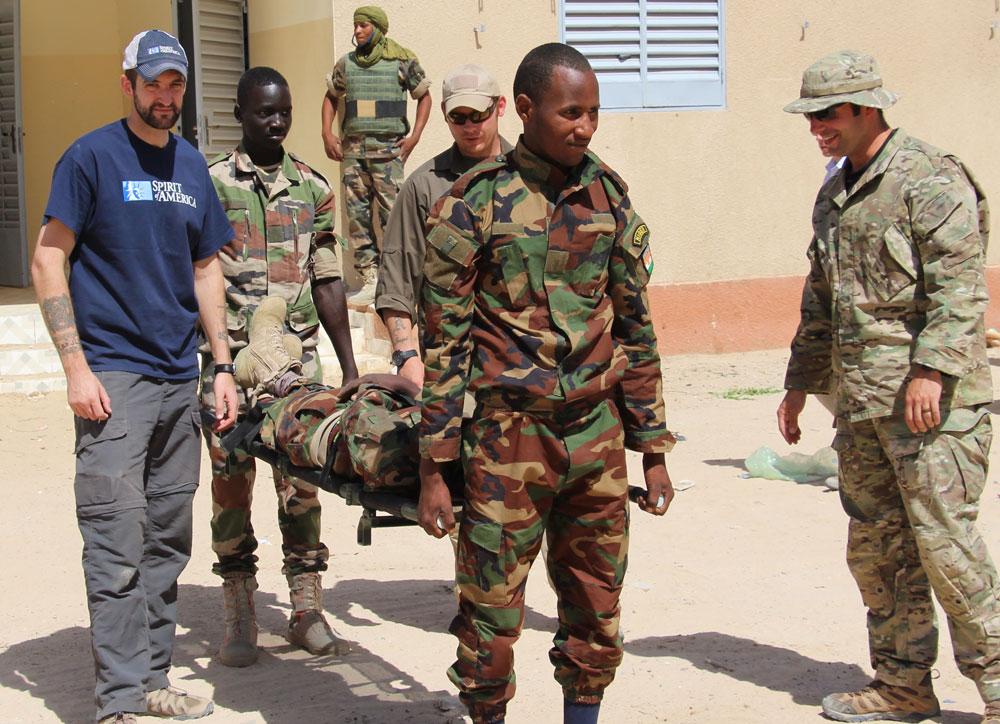 The soldiers practice using an SoA-provided stretcher with input from their US advisor