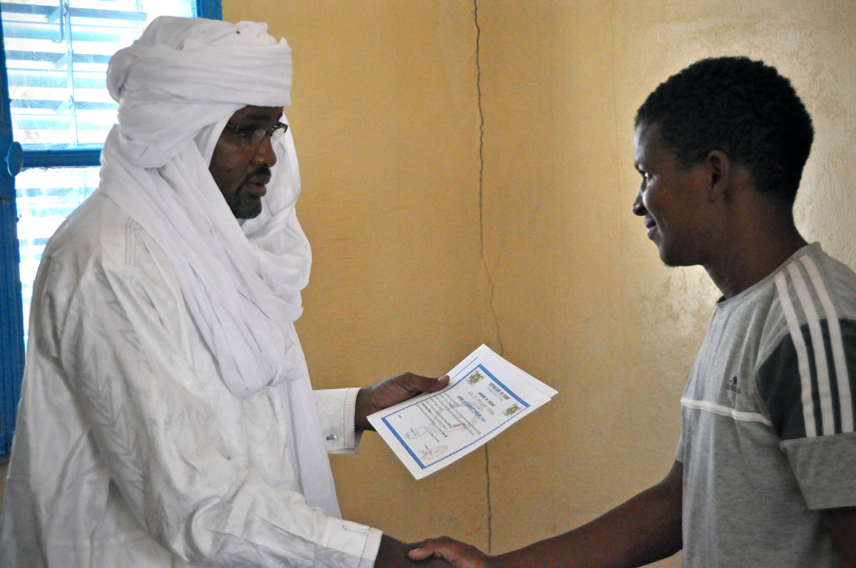 Ahmed receives his diploma from the Minister of Livestock at a ceremony in Ingall, Niger