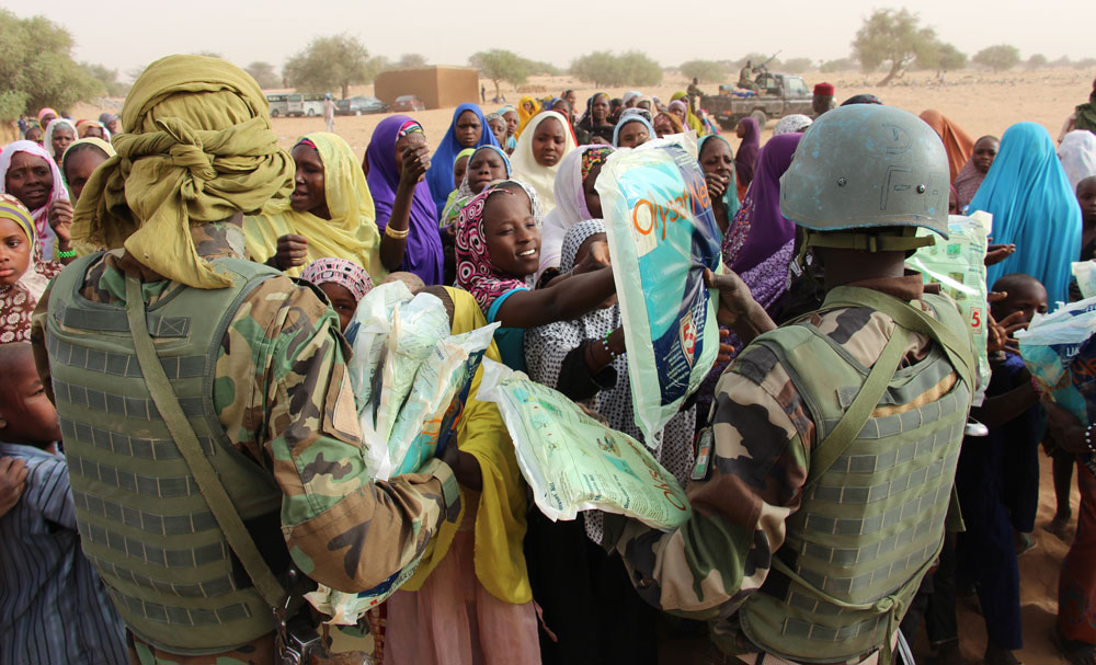 In addition to providing security, the soldiers also address the needs of the population. Here, they're giving mosquito nets to refugees forced out of their homes by Boko Haram.
