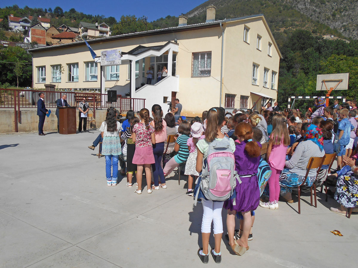 Students lined up to see their new classrooms as the US Ambassador discussed the importance of education