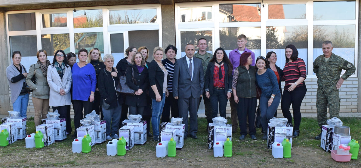The US team, their Kosovo Security Forces partners, and women from some of the villages stand behind the SoA-provided equipment needed to turn the training into businesses