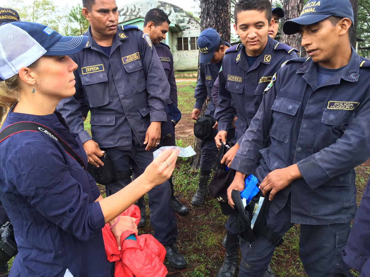 Honduran National Police discussing donated IFAK kits with SoA Rep Nicholette Doliva