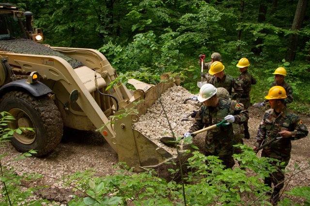 Moldovan and U.S. soldiers work together to build skills and forge stronger relationships while repairing a road