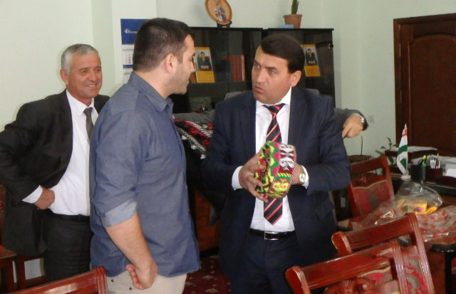 Gharm District Chairman, Kanoatsho Loikzada, giving SoA Middle East Field Operations Project Manager, Zack Bazzi, a traditional Tajik hat known as Tubeteika