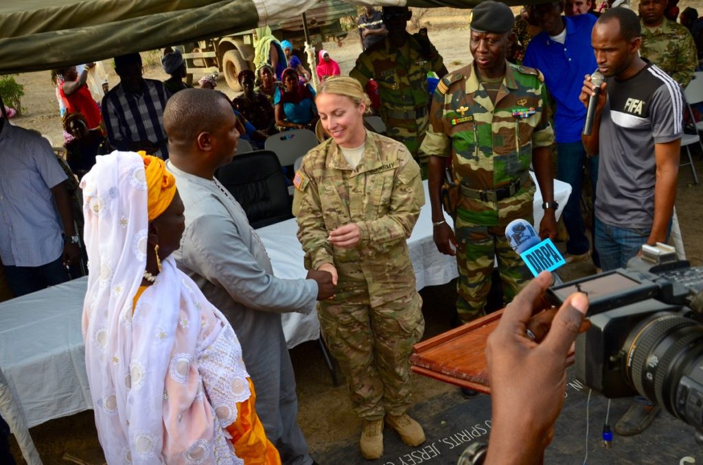 The US Civil Affairs Team Leader presents the warehouse keys to the Mayor of Kedougou, Co-Op President, and Regional Military Commander during the February dedication event