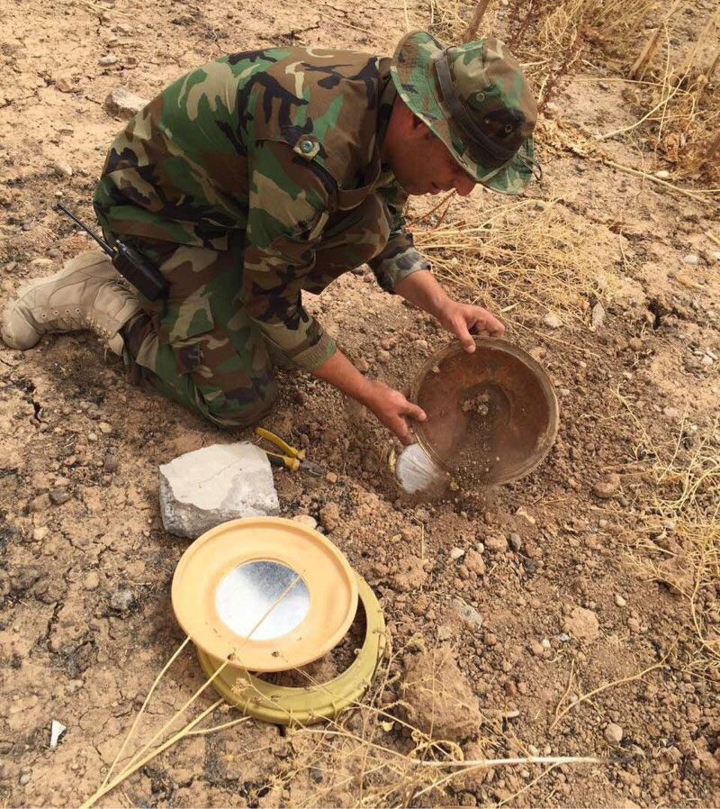 Captain Dilgash, Peshmerga commander, dismantling an ISIS-planted explosive device using tools provided by SoA