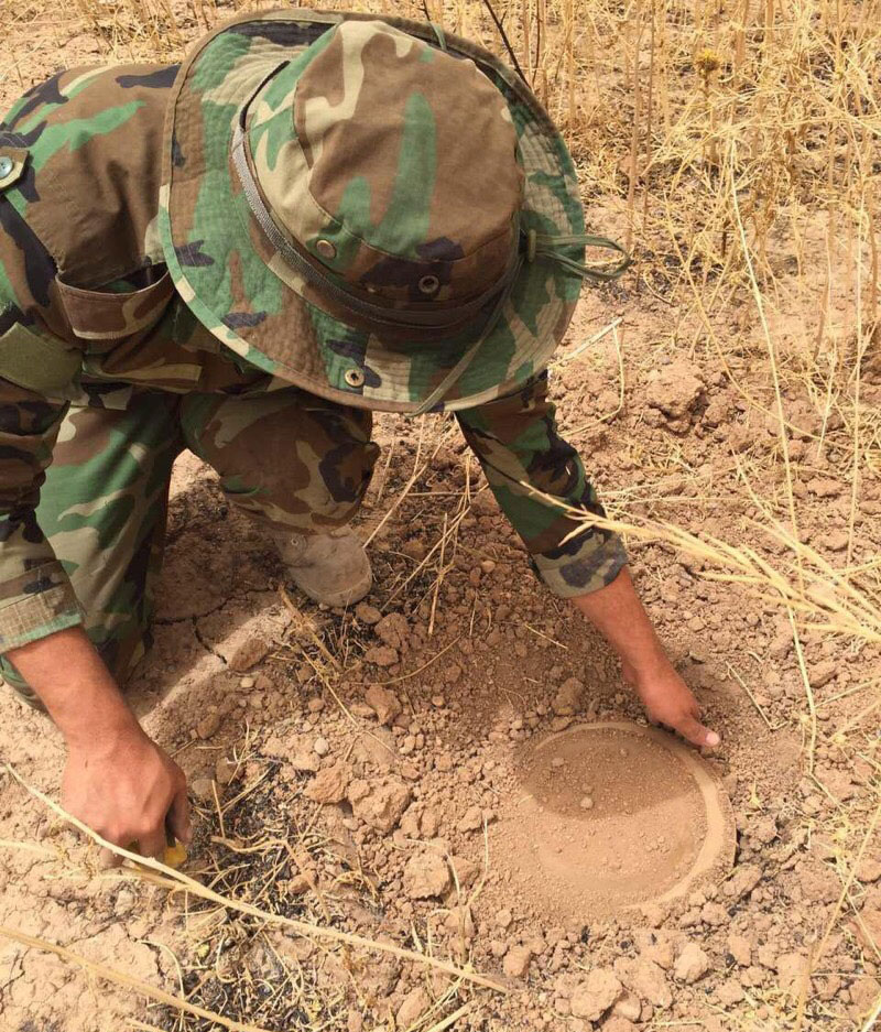 Captain Dilgash, Peshmerga commander, uncovering an ISIS-planted explosive device using tools provided by SoA