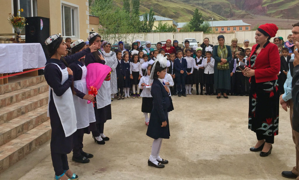 Young girls performing a song to the Deputy District Chairwoman as part of the school opening ceremony