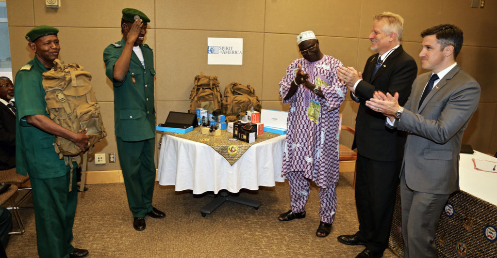 A representative of the Rangers salutes SoA’s Project Manager Chris, the US Deputy Chief of Mission, and a Representative of the Malian Ministry of Environment after receiving new equipment from SoA.