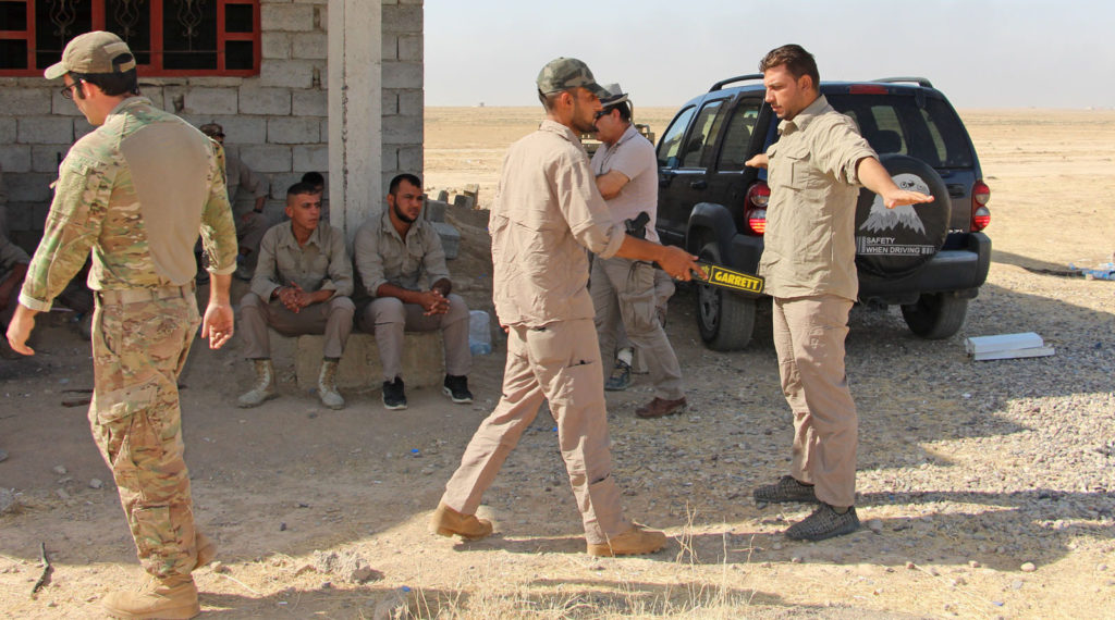 Iraqi tribal security forces practicing individual searching techniques on each other