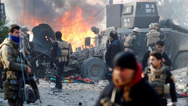 Iraqi Special Operations Forces (ISOF) react after a car bomb exploded during an operation to clear the al-Andalus district of ISIS militants, in Mosul, Iraq, January 16, 2017. (Courtesy of Press TV)