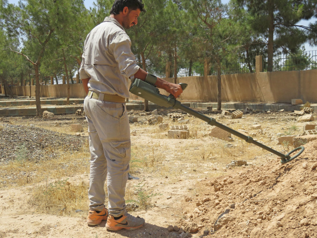 RMCO technician uses a metal detector to locate landmines in Syria