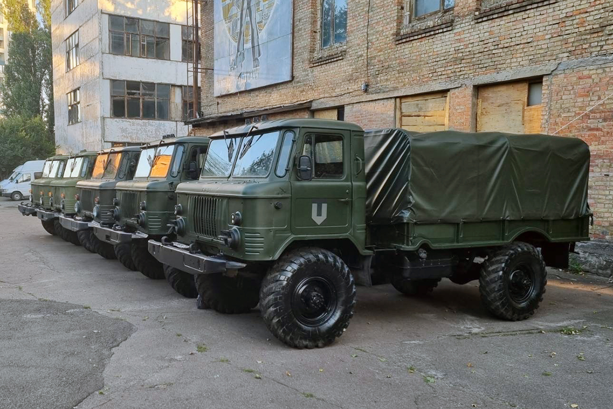 Line of military trucks rehabbed by the Ukrainian Territorial Defense Force