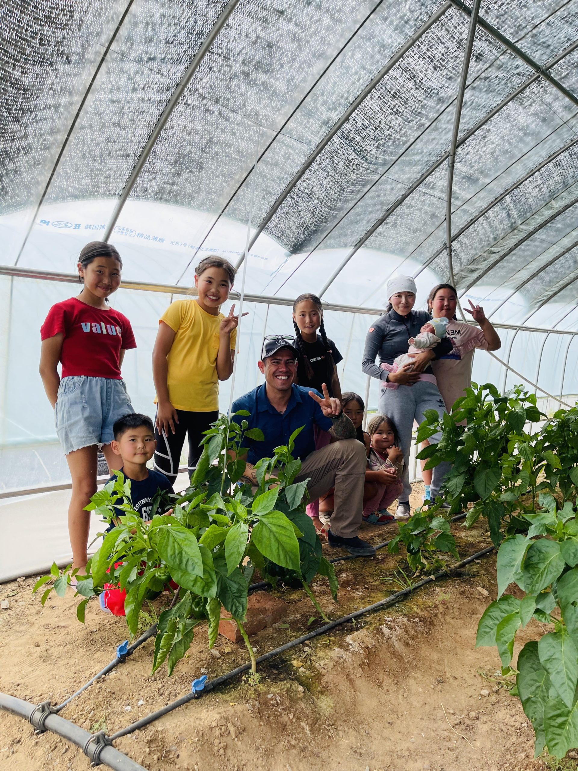 Danny Santos and kids in greenhouse